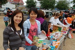 Wan and Nee offering food for the monks